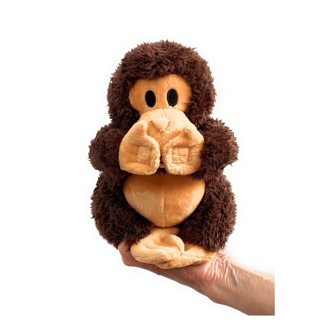Brown plush monkey toy in hand.