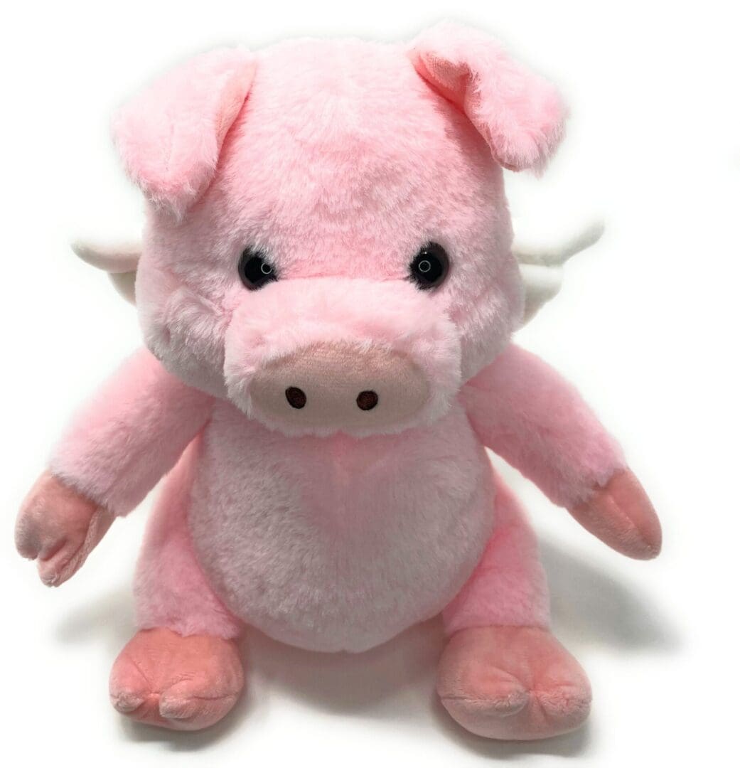 A pink stuffed pig with horns on its head.