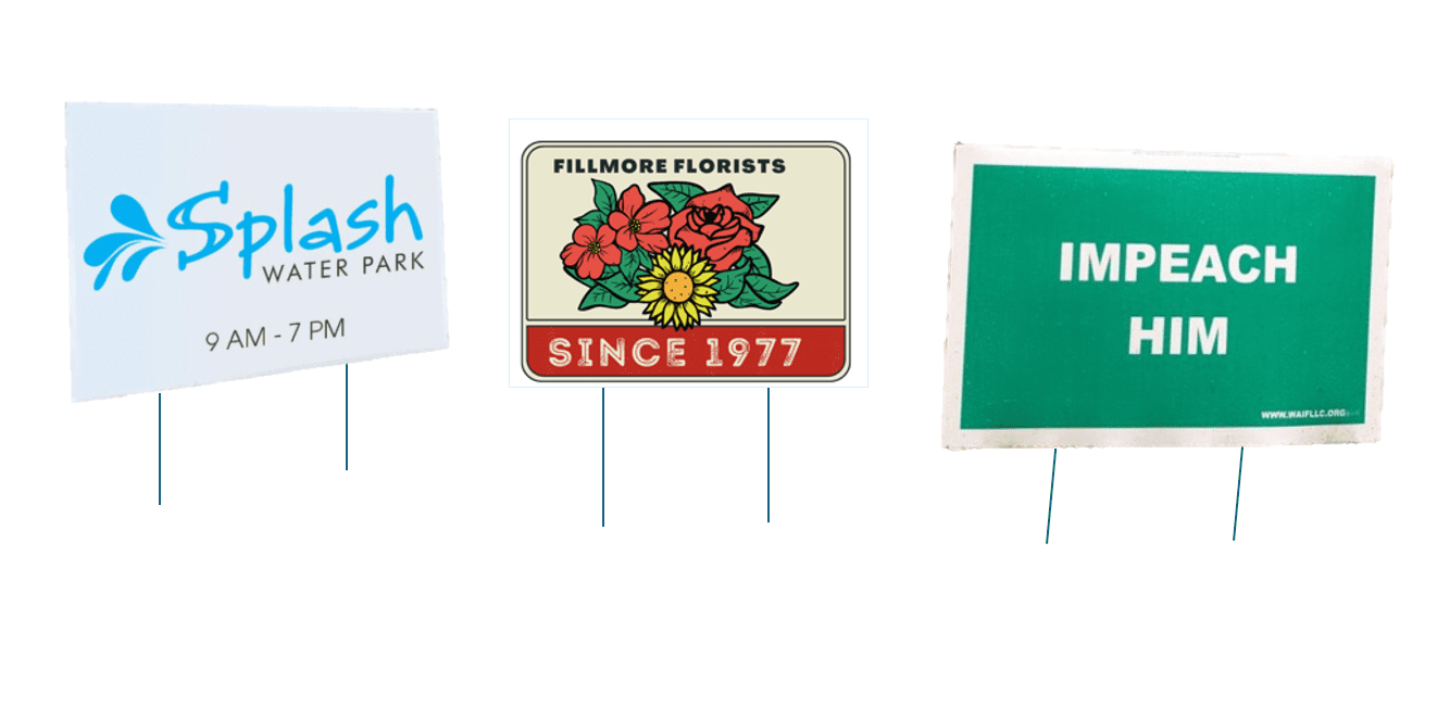 A group of four signs that are on top of sticks.
