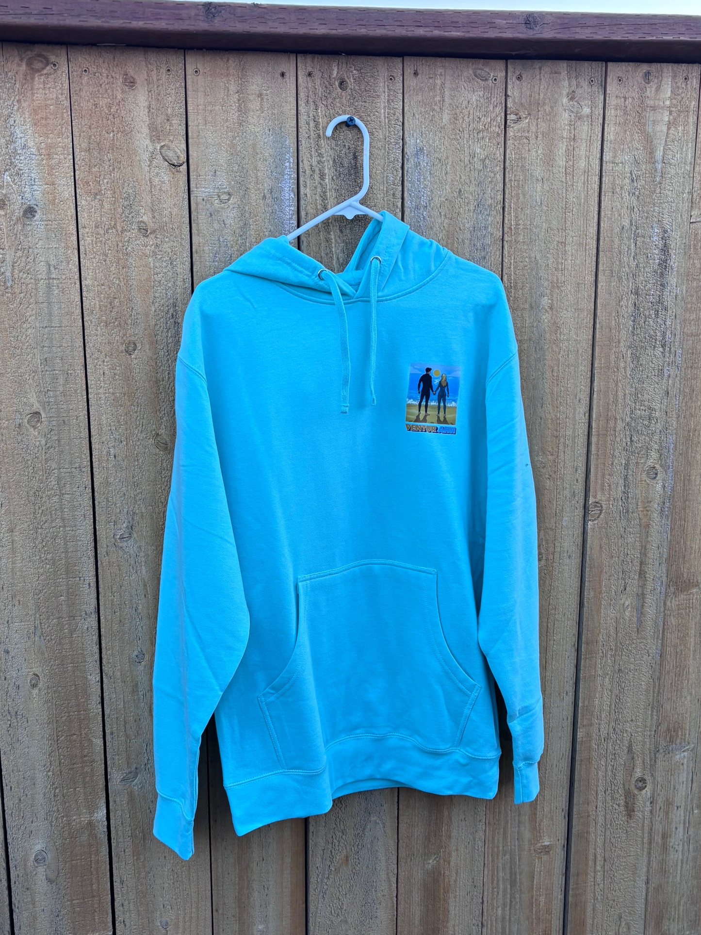 Ventura Vibes Hoodie – sky blue hoodie on hanger showing front chest graphic