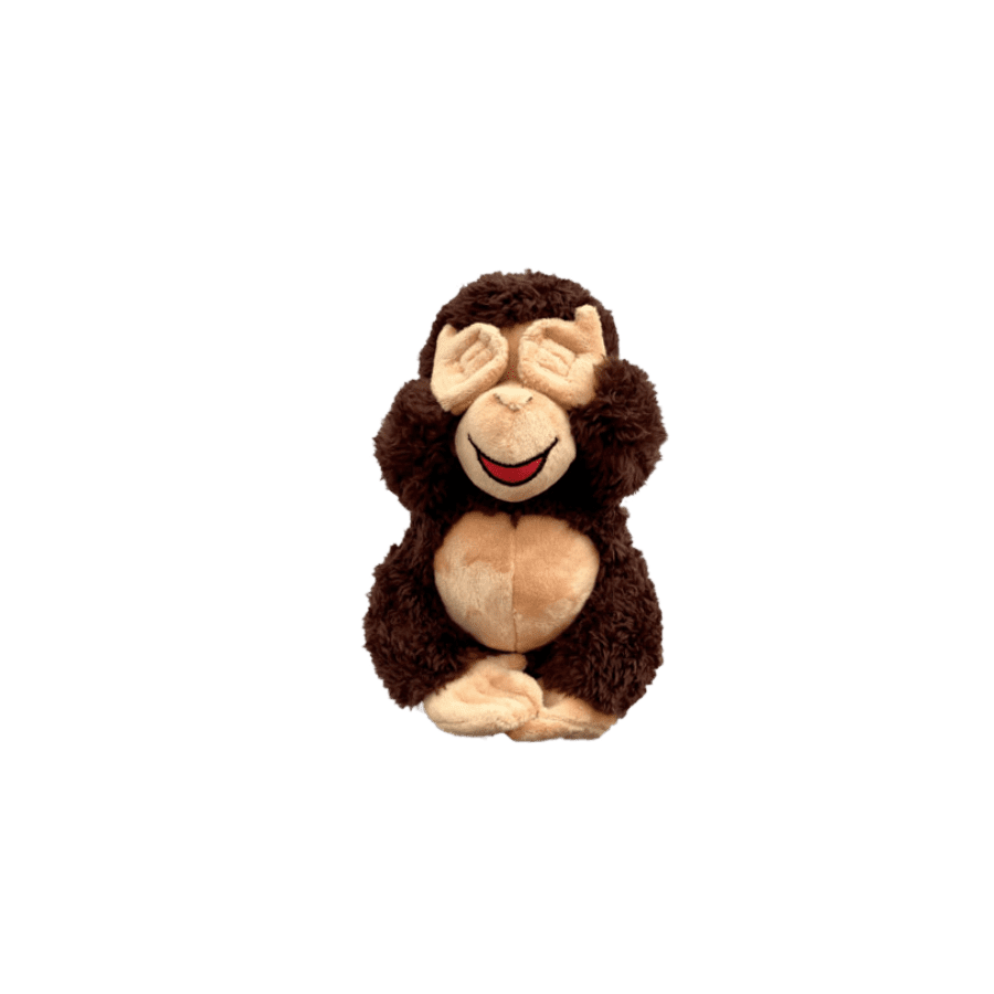 A stuffed monkey sitting on top of a green background.