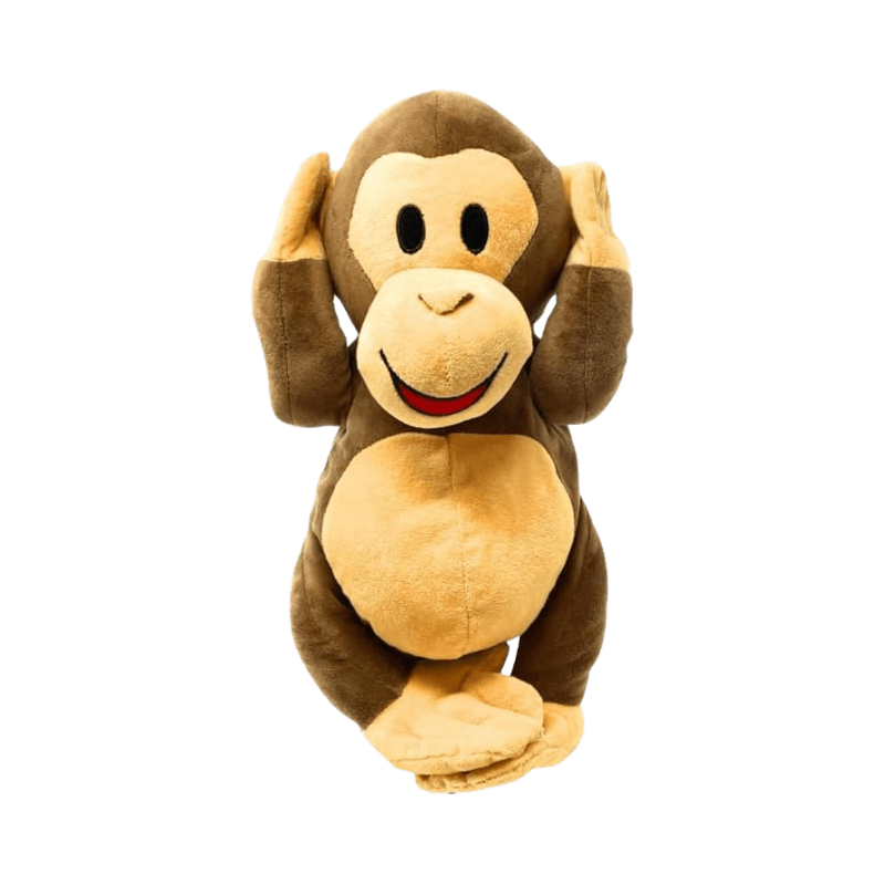 A stuffed monkey is sitting on the ground.