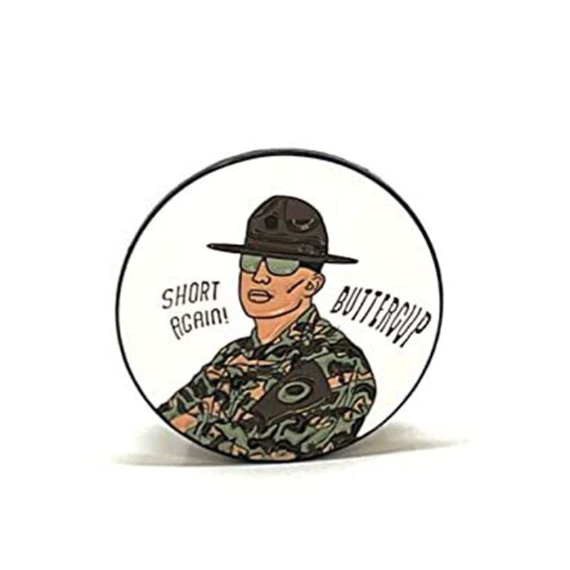 A pin with a picture of a man in camouflage.