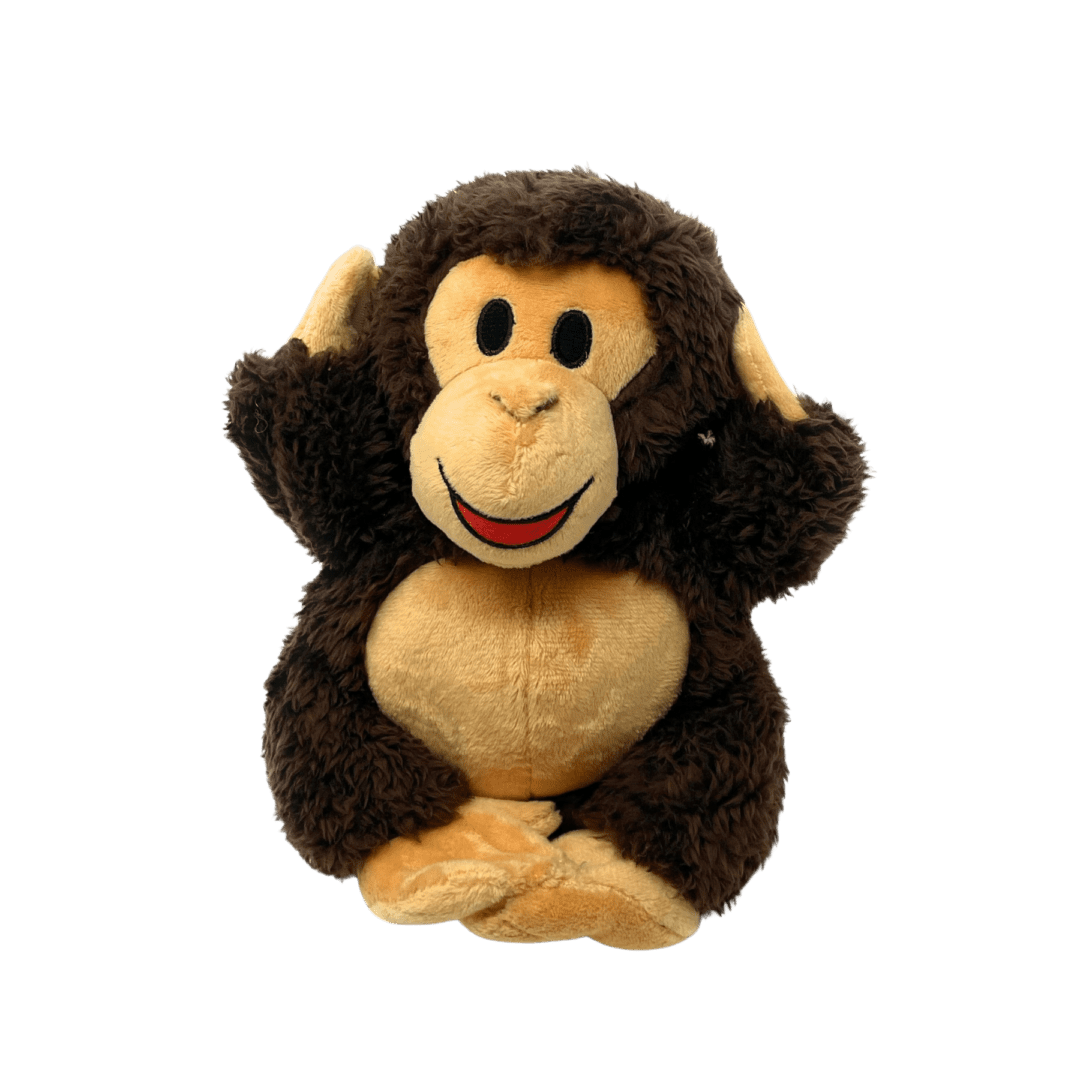 A stuffed monkey sitting on top of a green background.