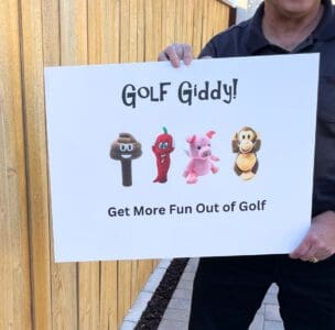 A man holding up a sign that says " golf giddy !"